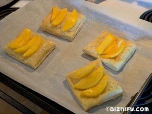 arranging mango on puff pastry